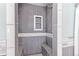 Tiled shower with built-in seat and pebble flooring at 12077 Ivy Ct, Brighton, CO 80602