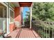 Relaxing balcony with seating, wrought iron railing, and views of mature trees at 300 Hudson St # 202, Denver, CO 80220
