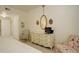 Bedroom features a dresser and television with a view into the ensuite bathroom at 300 Hudson St # 202, Denver, CO 80220