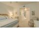 Bright bedroom with ensuite bathroom featuring neutral tones and carpeted floors at 300 Hudson St # 202, Denver, CO 80220