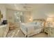 Cozy bedroom with a floral chair, shuttered windows, and neutral decor at 300 Hudson St # 202, Denver, CO 80220
