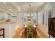 Sunny dining area with hardwood floors, shutters on the windows, and a decorative rug at 300 Hudson St # 202, Denver, CO 80220