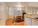 Bright dining area featuring hardwood floors, a cowhide rug, and a chandelier above the wooden table at 300 Hudson St # 202, Denver, CO 80220