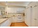 Functional kitchen featuring white appliances, cabinetry, and hardwood floors at 300 Hudson St # 202, Denver, CO 80220