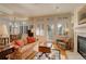 Inviting living room with large windows, shutters, and a cozy fireplace at 300 Hudson St # 202, Denver, CO 80220
