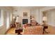 Comfortable living room featuring a fireplace, hardwood floors, and ample seating at 300 Hudson St # 202, Denver, CO 80220