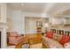 Cozy living room with hardwood floors, a fireplace, and access to the kitchen at 300 Hudson St # 202, Denver, CO 80220
