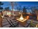 Backyard patio featuring a modern fire pit and outdoor seating, set against a backdrop of a well-maintained lawn at 1486 S Elm St, Denver, CO 80222