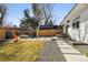 Spacious backyard featuring a patio, fire pit, gravel accents, and a grassy lawn at 1486 S Elm St, Denver, CO 80222