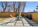 Backyard patio with concrete pavers, gravel, Adirondack chairs, and a privacy fence at 1486 S Elm St, Denver, CO 80222