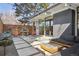 Modern backyard patio featuring concrete pavers, built-in seating, grill, and stylish outdoor furniture at 1486 S Elm St, Denver, CO 80222