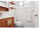 Bright bathroom with a modern vanity, floating shelves, and white subway tile at 1486 S Elm St, Denver, CO 80222