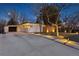 View of the home's modern exterior and long driveway with inset lighting creating an appealing and welcoming curb appeal at 1486 S Elm St, Denver, CO 80222