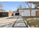 Striking mid-century modern exterior features a modern walkway, attached garage, and privacy fence at 1486 S Elm St, Denver, CO 80222