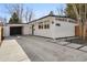 Contemporary home showcasing an attached carport, xeriscaped front yard and modern design at 1486 S Elm St, Denver, CO 80222