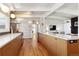 Well-lit kitchen with stainless steel appliances, a breakfast bar, and ample counter space at 1486 S Elm St, Denver, CO 80222