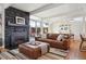 Cozy living room with a stone fireplace, comfortable seating, and sliding glass doors to the outside at 1486 S Elm St, Denver, CO 80222