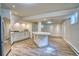 Finished basement with luxury vinyl plank flooring, a kitchen area, and access to natural light at 1834 Hennington Ct, Longmont, CO 80501