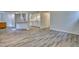 Spacious basement area showcasing modern flooring, ample lighting, and a functional kitchenette at 1834 Hennington Ct, Longmont, CO 80501