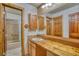 Rustic bathroom featuring wood accents, a large mirror, and a shower-tub combo for a spa-like feel at 1834 Hennington Ct, Longmont, CO 80501