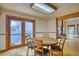 Charming dining area with hardwood floors, wood trim, and access to the backyard through French doors at 1834 Hennington Ct, Longmont, CO 80501