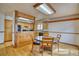 Cozy dining area featuring wood floors, wood trim, and bright lighting at 1834 Hennington Ct, Longmont, CO 80501