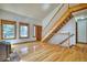 Warm and inviting foyer with hardwood floors and a wooden staircase leading to the upper level at 1834 Hennington Ct, Longmont, CO 80501