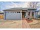 Charming single Gathering home with a well-maintained lawn and a spacious two-car garage at 1834 Hennington Ct, Longmont, CO 80501