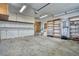 A functional two car garage featuring built-in shelving and ample storage cabinets for organization and convenience at 1834 Hennington Ct, Longmont, CO 80501