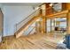 Spacious foyer with hardwood floors and staircase leading up to second story with wooden railings at 1834 Hennington Ct, Longmont, CO 80501