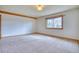 Spacious main bedroom with carpet and large window with natural light at 1834 Hennington Ct, Longmont, CO 80501