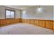 Bright room with wood paneling and a large window at 1834 Hennington Ct, Longmont, CO 80501