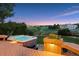 Backyard view of a hot tub and flower garden in the evening light, creating a peaceful ambiance at 10085 Charissglen Ct, Highlands Ranch, CO 80126