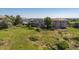 Aerial view of the home and backyard with green lawn, privacy fence and hot tub at 10085 Charissglen Ct, Highlands Ranch, CO 80126