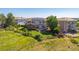 Backyard aerial view with green lawn, wooden pergola on deck, privacy fence and hot tub at 10085 Charissglen Ct, Highlands Ranch, CO 80126