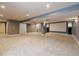 Spacious finished basement features plush carpeting, in-home theater, projector, and access to other rooms at 10085 Charissglen Ct, Highlands Ranch, CO 80126