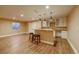 Finished basement featuring wood floors, and a bar seating area at 10085 Charissglen Ct, Highlands Ranch, CO 80126