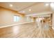 Open basement with luxury vinyl plank flooring, recessed lighting and a kitchenette at 10085 Charissglen Ct, Highlands Ranch, CO 80126