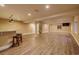 Open basement featuring wood floors, bar area, and natural lighting at 10085 Charissglen Ct, Highlands Ranch, CO 80126