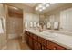 Bright bathroom featuring a double sink vanity and a shower tub combo at 10085 Charissglen Ct, Highlands Ranch, CO 80126