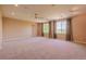 Spacious bedroom featuring carpet floors, large windows, and modern ceiling fan at 10085 Charissglen Ct, Highlands Ranch, CO 80126