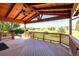 Wide, covered deck boasts wooden beams, a ceiling fan, and a beautiful view at 10085 Charissglen Ct, Highlands Ranch, CO 80126