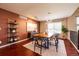 Open-concept dining room with modern lighting, hardwood floors, and neutral paint at 10085 Charissglen Ct, Highlands Ranch, CO 80126