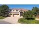Charming two-story stucco home with a three-car garage and landscaped front yard at 10085 Charissglen Ct, Highlands Ranch, CO 80126