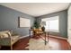 Comfortable home office featuring hardwood floors, a stylish desk, and a cozy armchair for a productive workspace at 10085 Charissglen Ct, Highlands Ranch, CO 80126