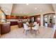 Bright, open kitchen with custom cabinets, tile backsplash, stainless appliances, and a breakfast nook at 10085 Charissglen Ct, Highlands Ranch, CO 80126