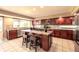 Spacious gourmet kitchen with custom cabinetry, island cooktop, and tile floors at 10085 Charissglen Ct, Highlands Ranch, CO 80126