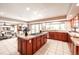 Open kitchen features a central island cooktop and a window offering views of the outdoors at 10085 Charissglen Ct, Highlands Ranch, CO 80126