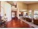 Open-concept foyer and living area with hardwood floors, neutral paint, and soaring ceilings at 10085 Charissglen Ct, Highlands Ranch, CO 80126