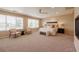 Spacious main bedroom boasts large windows, plush carpet, and a cozy seating area for ultimate relaxation at 10085 Charissglen Ct, Highlands Ranch, CO 80126
